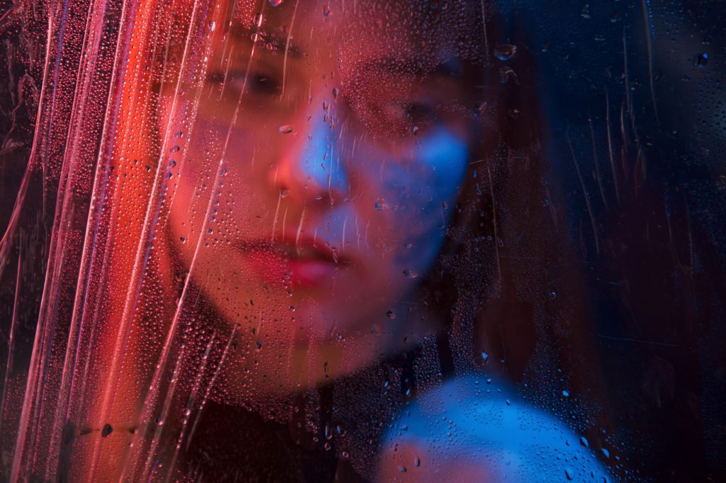 sad-woman-studio-shot-in-dark-studio-with-neon-lig-68PKJPV