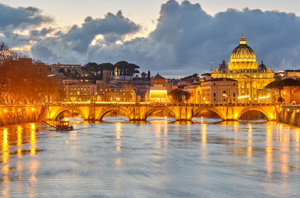 St. Peter's cathedral and Tiber river at evening in Rome