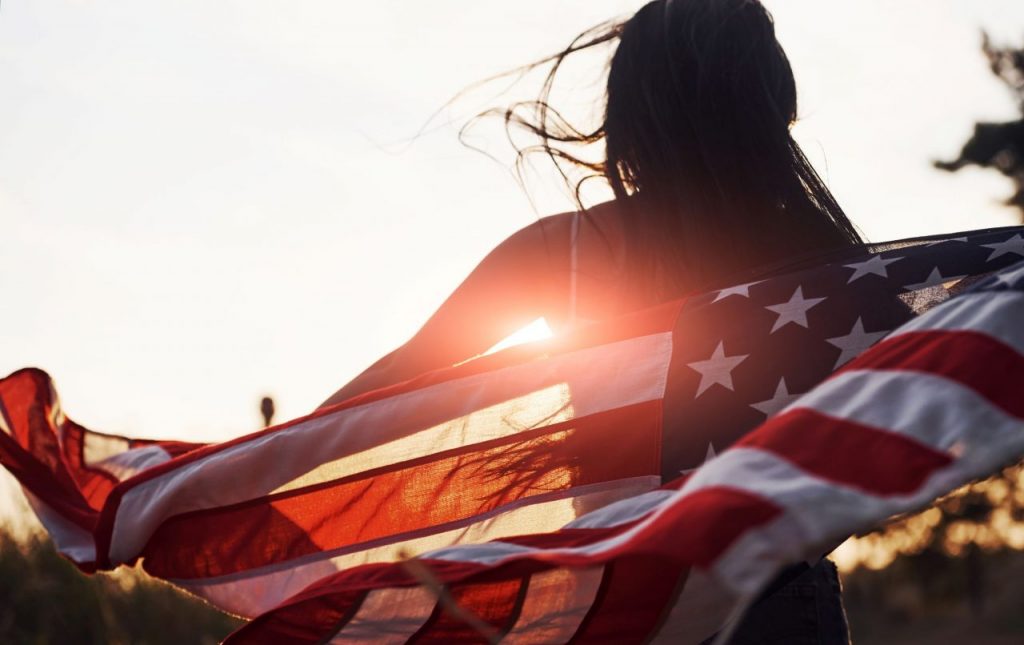 brunette-with-usa-flag-in-hands-have-a-good-time-a-23KTGPK