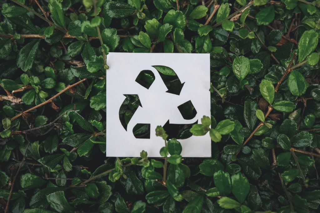 recycle-symbol-created-with-paper-cut-on-green-lea-MAKDWWB
