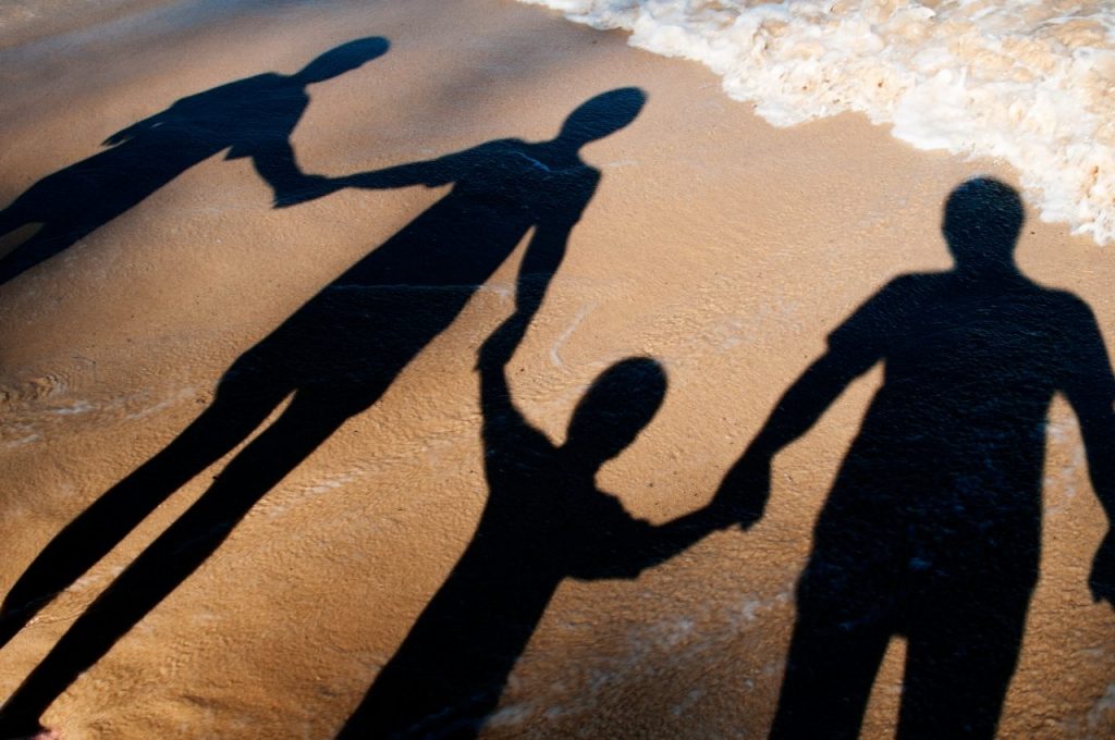 shadow-of-adults-and-children-holding-hands-on-the-DNSJC4B