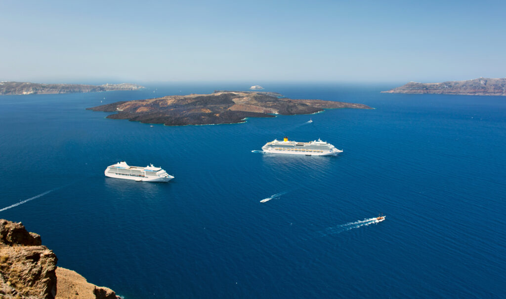 cruise ship near volcano on island of Santorini
