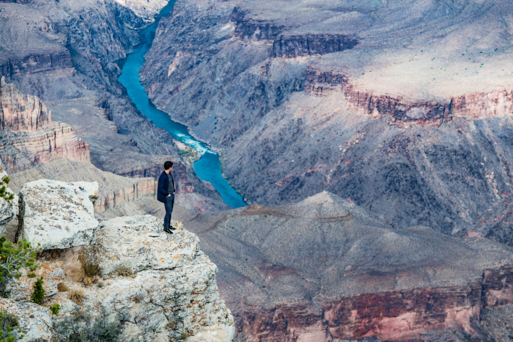 A Man Standing on the Rim of the Grand Canyon